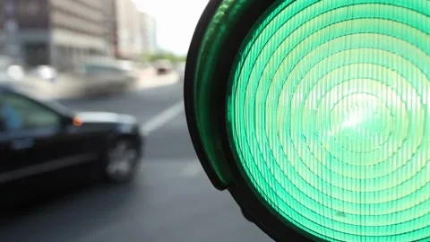 Close-up shot captures a traffic light transitioning from red to green in Stock Footage 256738066