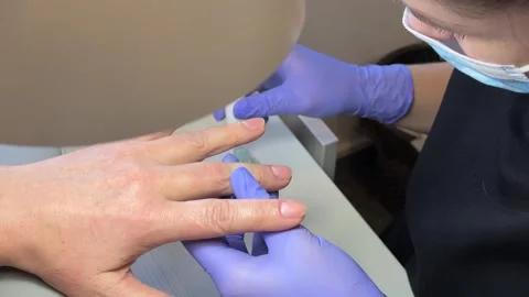 A close-up shot capturing the intricate process of a manicure, highlighting the Stock Footage 324592320