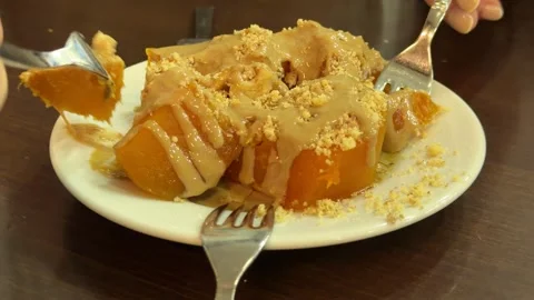 Close-up shot capturing a person enjoying Turkish pumpkin dessert Stock Footage 340155084