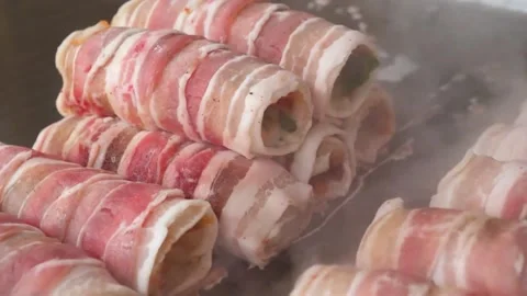 Close-up shot capturing the vibrant, sizzling process of cooking Cheese Bacon Ki Video stock 343587997