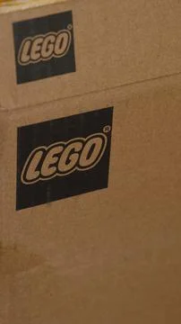 A close-up shot of a cardboard box featuring the printed black Lego logo Stock Photos