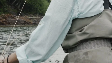 Close up shot as casting with a fly fishing rod moving it back and forth Stock Footage 99852565