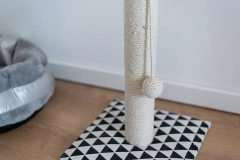 Close-up shot cat scratching post sisal rope toy ball on patterned mat Stock Photos