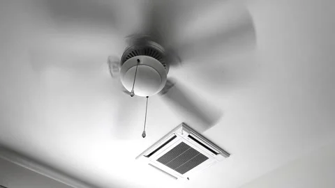 Close-up shot ceiling fan runs next to an airconditiong vent Stock Footage 291463916