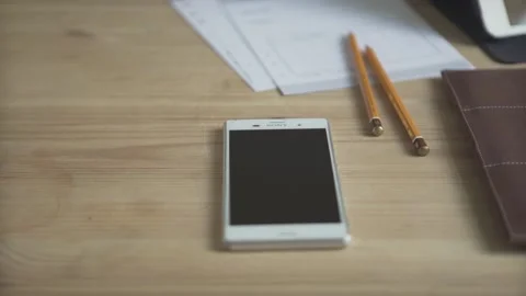 Close up shot of cell phone light brown leather daily planner bullet journal hab Stock Footage 137538724