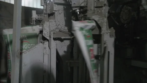 Close up shot of cement packaging in the machine Stock Footage 106379285
