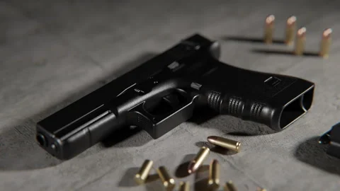 Close up shot of a CGI Handgun on the floor and bullets around it Stock Footage 253622307