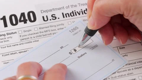 Close-up shot of a check being written for taxes 動画素材 247794712