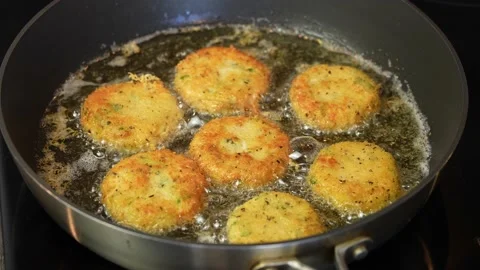 Close up shot of cheese snacks fried rotating in a frying pan. Preparing healthy Stock Footage 171878402