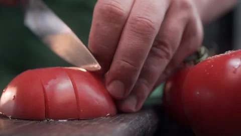 Close up shot chef cuts tomato in a cubes for salad Video stock 143781320