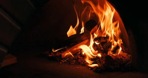 Close-up shot of chef fixing coals wood in the fire. Firewood burns in a stone Stock Footage 247484823