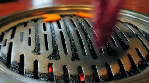 Close-up shot of chef hand cooking korean grilled meat on iron grill pan in Stock Footage 118063305