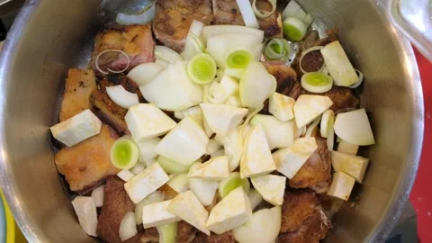 Close up shot of chef hand cooking meat in a frying pan. Cooking pork belly on a Stock Footage 221908131