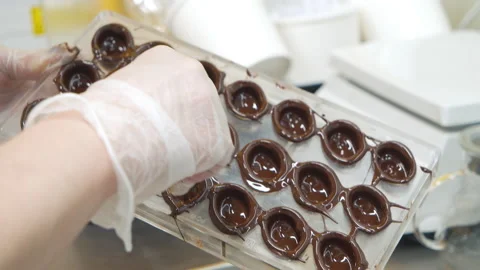 Close-up shot of a chef hands in gloves preparing delicious dark chocolate Stock Footage 150959747