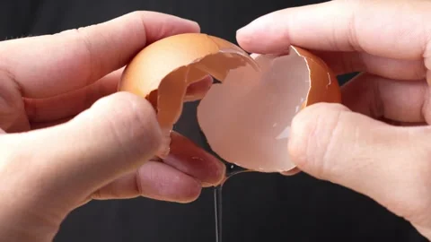 Close Shot Chef Hands Opening Raw Egg and Removing Yolk Macro Studio Shot Stock Footage 328490569