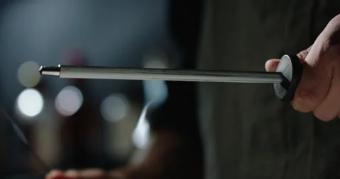 Close up shot of chef sharpening a cool knife before cutting meat or making a 스톡 동영상 144564887