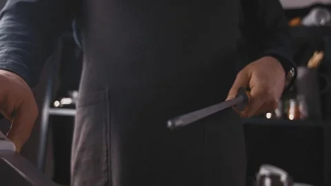Close-up shot of chef sharpens knife for cooking, chef preparing his knife. Chef Stock Footage 154674501