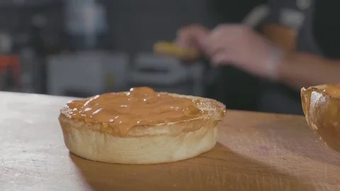 Close-up shot of chef's hands preparing a hamburger with beef rissole and cheese Stock Footage 80676517