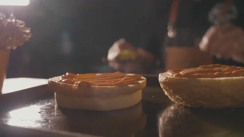 Close-up shot of chef's hands preparing a hamburger with beef rissole and cheese Stock Footage 80676917