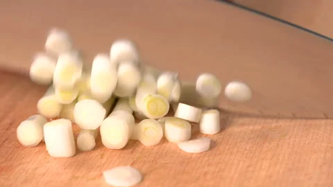 Close up shot of chef's hands using a knife cutting a green onion Stock Footage 157418784
