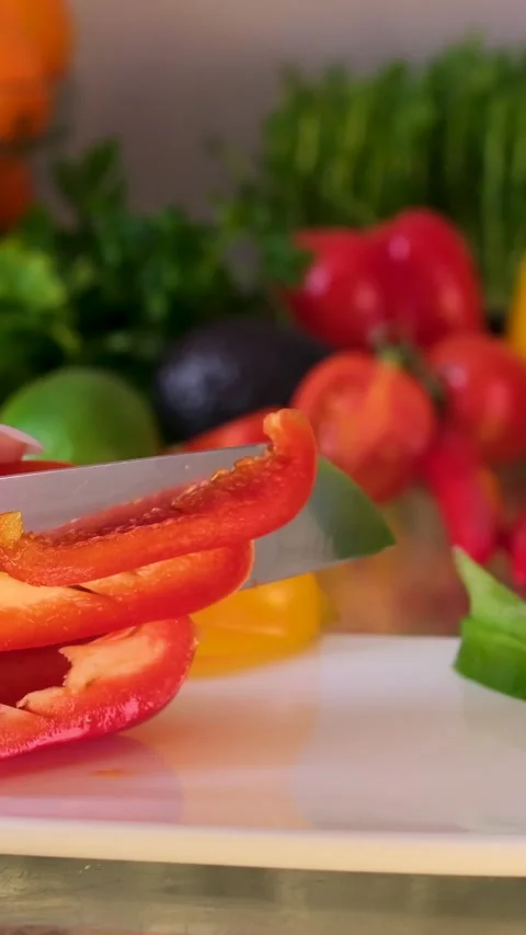 Close up shot of chef's hands using a knife cutting a fresh bell pepper on Vídeo Stock 302074361