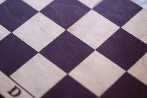 A close-up shot of a chess board featuring a classic checkerboard pattern Stock Photos