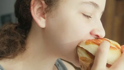 Close up shot of child biting hamburger. Hungry girl eating unhealthy food. Girl Stock Footage 329317988