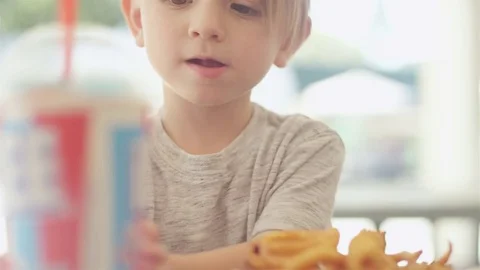 Close up shot of a child drinking his beverage at a park Stock Footage