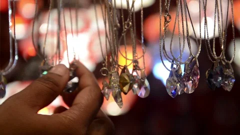 Close shot of choosing stone locket by customer. Video stock 89477386
