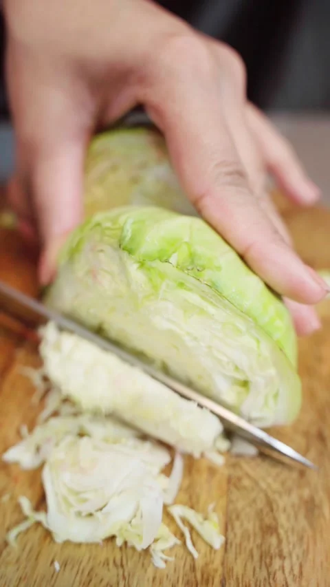 Close up shot of Chopping cabbage with a knife on cutting board. Stock Footage 283361535