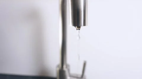 Close-up shot chrome plated trendy leaking faucet water dripping into sink Stock Footage 322811821