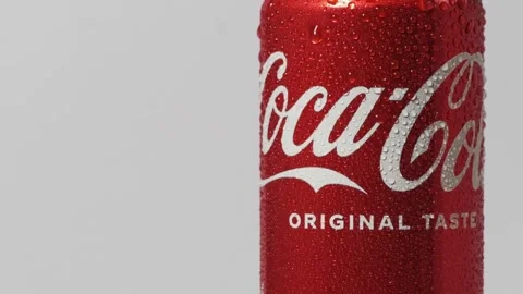 Close up shot of classic Coca-Cola red can rotating on the white background Stock Footage 242419925