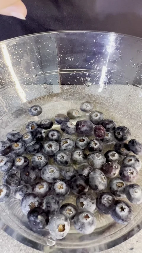 Close up shot of Cleaning jamun known as Java plum in a glass bowl. Video stock 287811285
