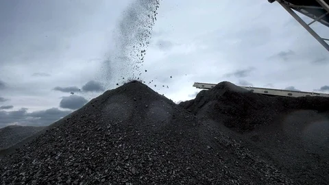 A close-up shot of a coal falling from the belt conveyor at the coal mine Stock Footage 101502048
