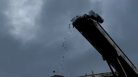 A close-up shot of a coal falling from the belt conveyor at the coal mine Stock Footage 101502753