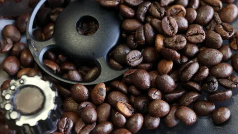 Close up shot of coffee beans falling into the grinder of a coffee maker. Stock Footage 196219361
