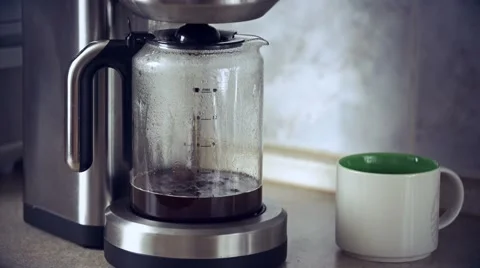 Close-up shot of coffee brewing in coffee maker and flowing in to carafe Stock Footage 61518808
