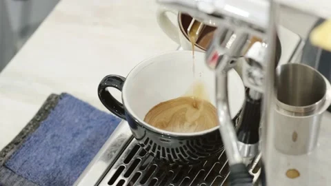 Close Up Shot of Coffee Dripping from An Espresso Machine into a Mug Stock Footage 219992669