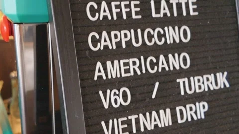 Close up shot of a coffee shop menu board displaying various types of coffee dri 库存影片 343399617