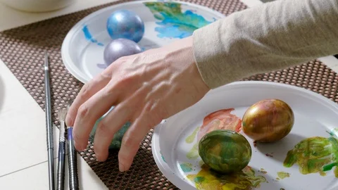 Close-up shot of colorful Easter eggs on a kitchen table. 4K Stock Footage 123004740