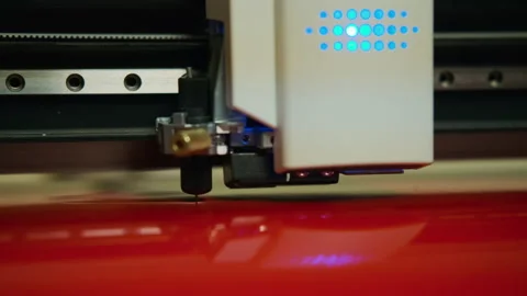 Close up shot of Commercial plotter is cutting a red paper Stock Footage 221708487