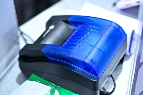 Close-up shot of a compact black thermal receipt printer featuring a promin.. Stock Photos
