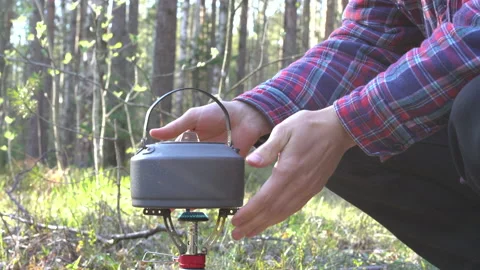 Close shot a compact kettle for hiking is heated on a gas burner 動画素材 130195133