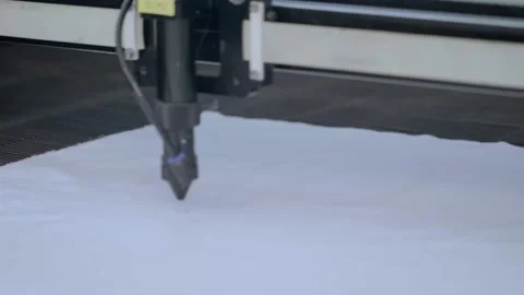 Close-up shot of Computerized laser cutting machine making pattern on clothing.  Stock Footage 136040709
