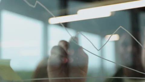 Close-up shot of concentrated man analyst, standing in front of glass wall and Stock Footage 155172854