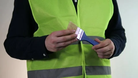 A close-up shot of a construction workers hands, clad in a light-reflecting Stock Footage 318213026