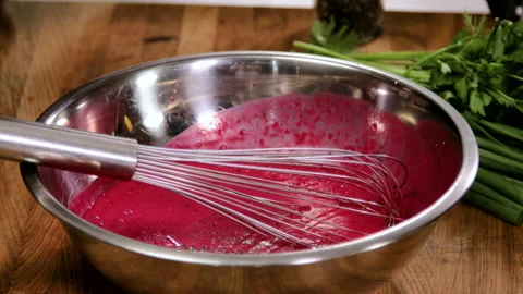Close-up shot of a cook mixing the white yogurt and beet juice in a bowl. 4K Stock Footage 136845192