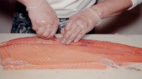Close up shot the cook remove bones from fresh red fish Stock Footage 65507702