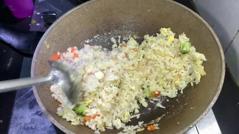 Close-up shot of a cooking fried rice in a hot wok on a stove Stock Footage 296626698