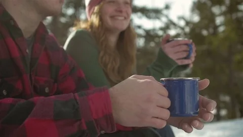 Close up shot of a couple drinking coffee together on a snowy day Stock Footage 83613933